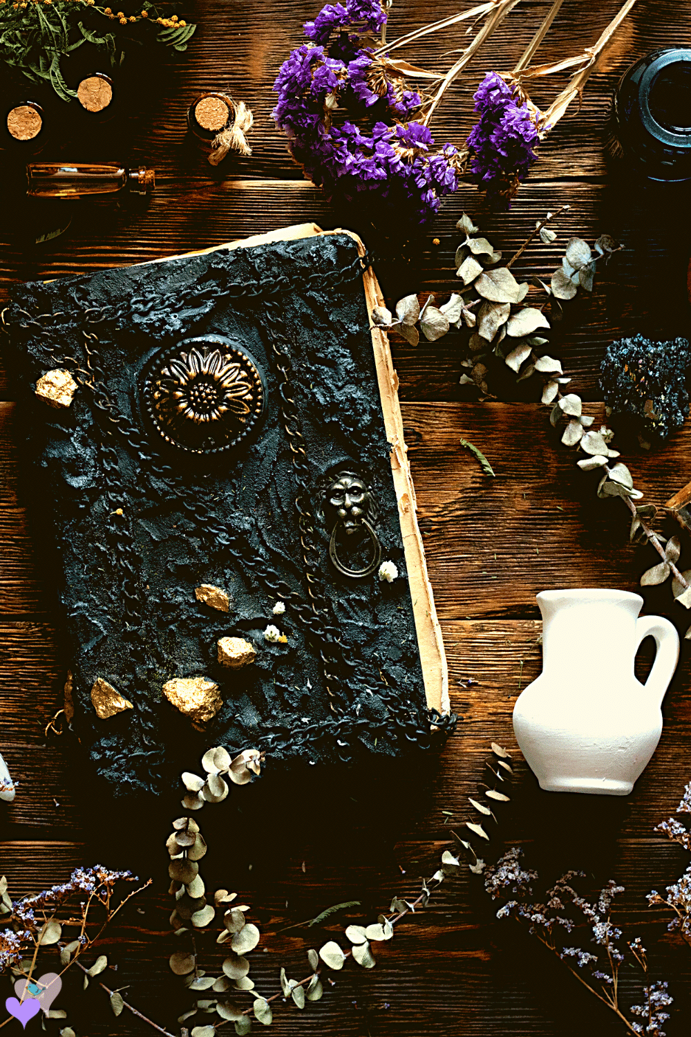 witches table filled with magic spell books, potions and herbs