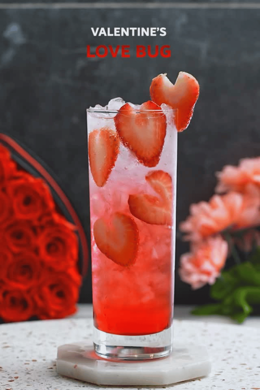 Cranberry and vodka Valentine love bug cocktail with strawberries