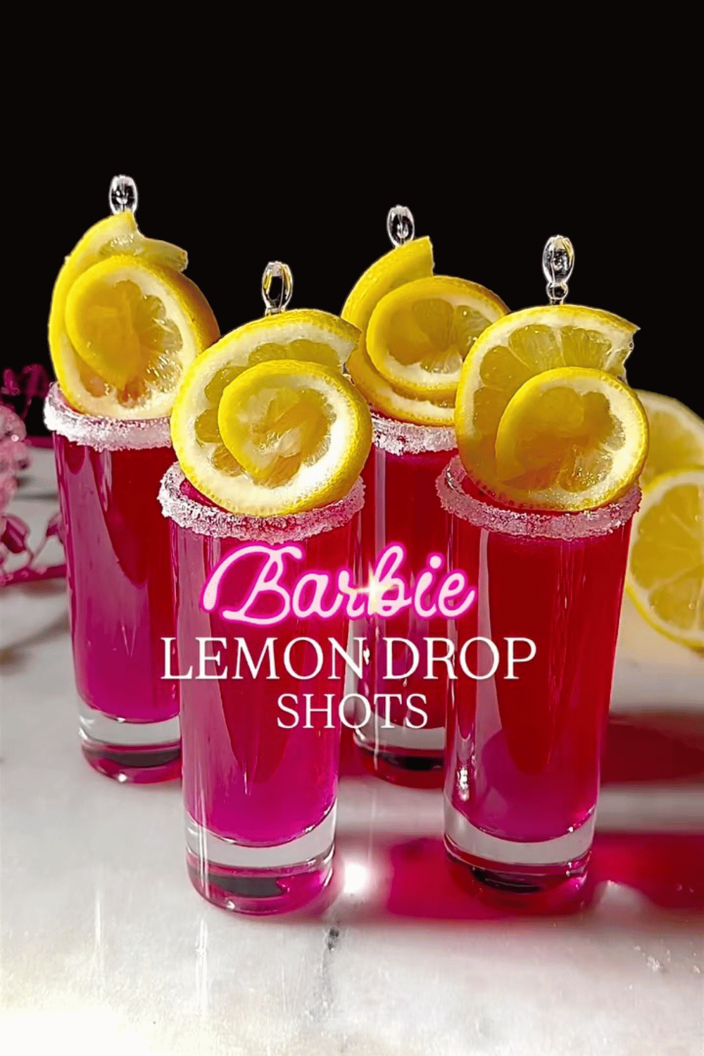 Pink lemon drop shots with sugar rim and lemon garnish