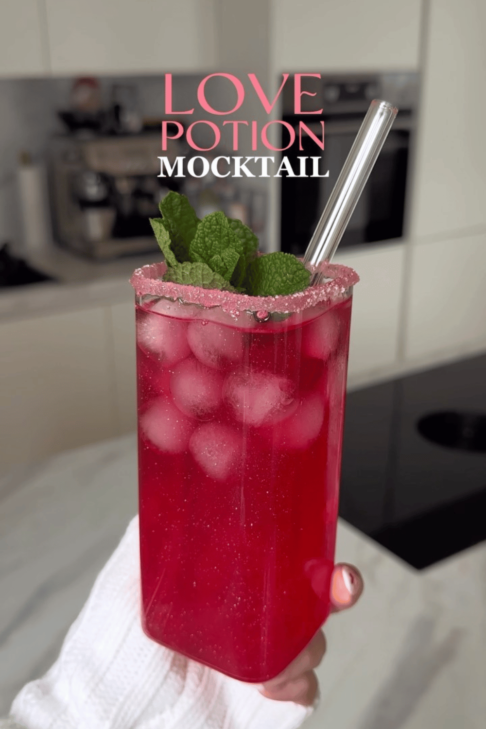 Love potion mocktail with heart ice cubes and mint