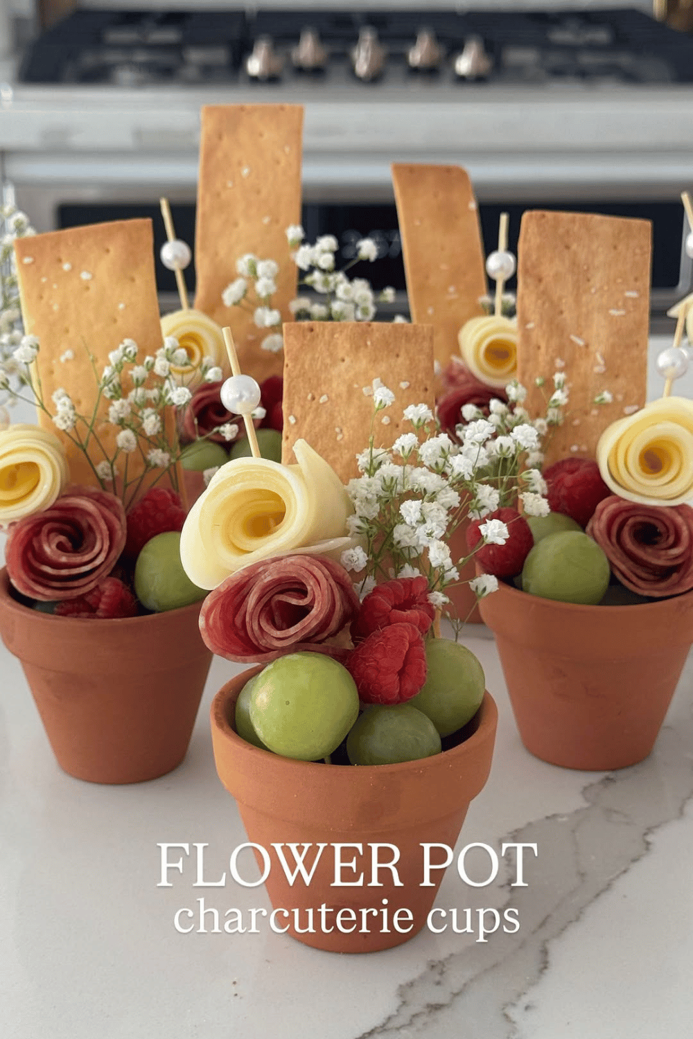 Flower pot charcuterie cups with cheese, grapes, and crackers