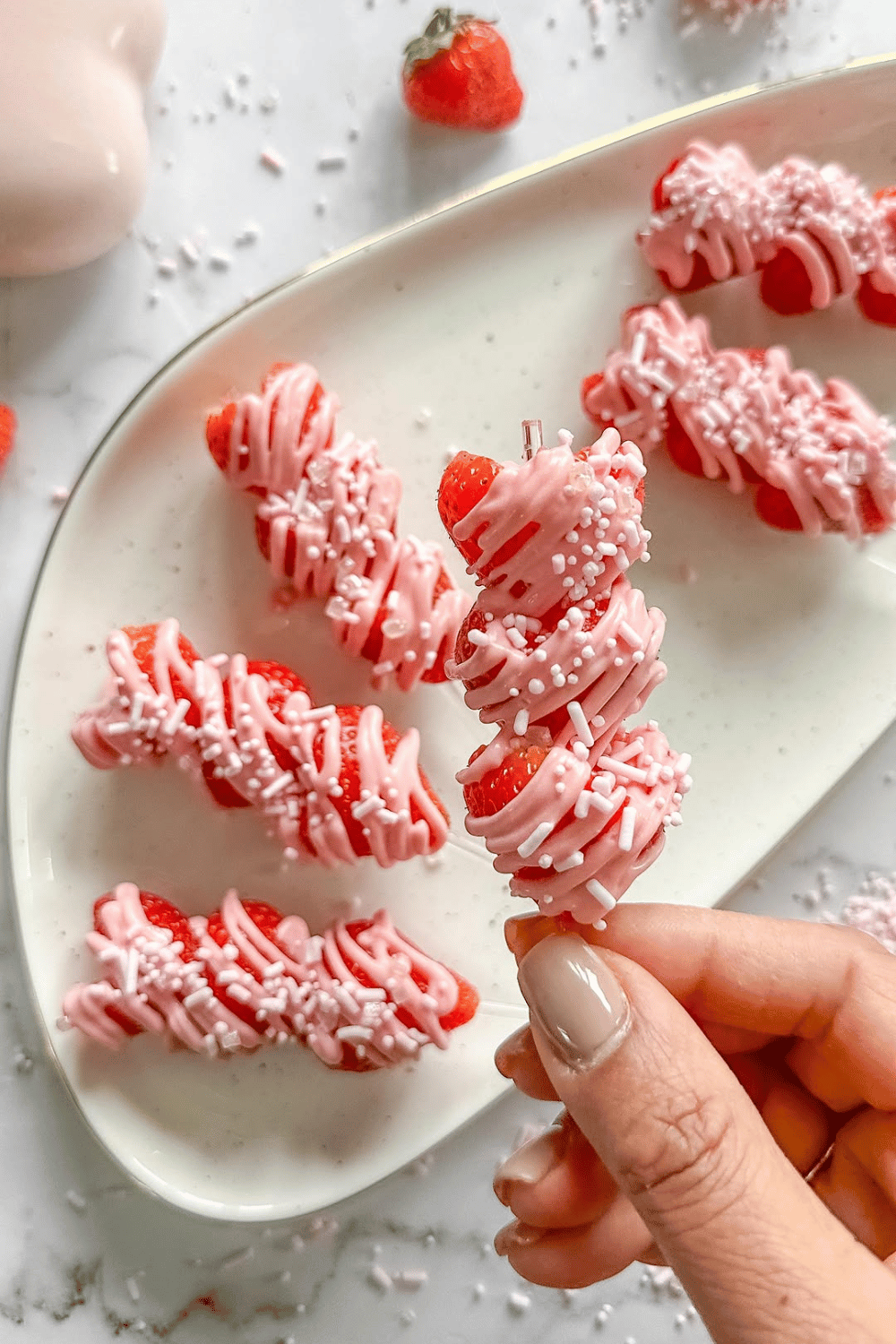 Strawberry skewers dipped in pink chocolate