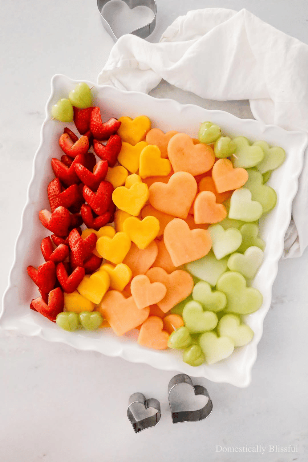 Heart-shaped fruit platter with melon and strawberries