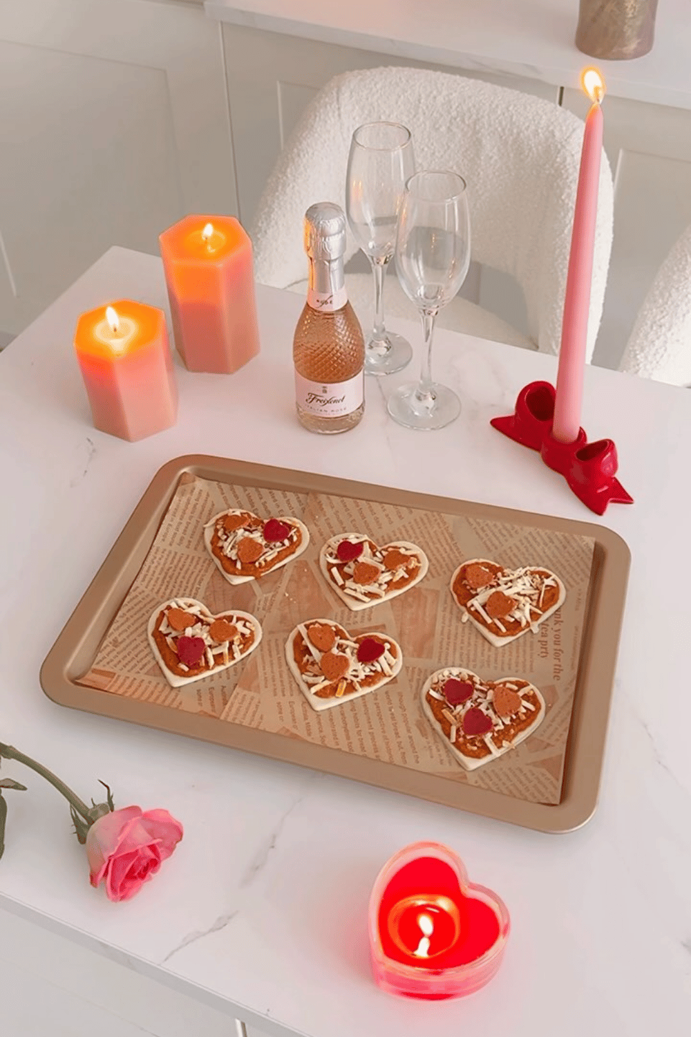 Heart pizza snacks with candles and Valentine’s decor
