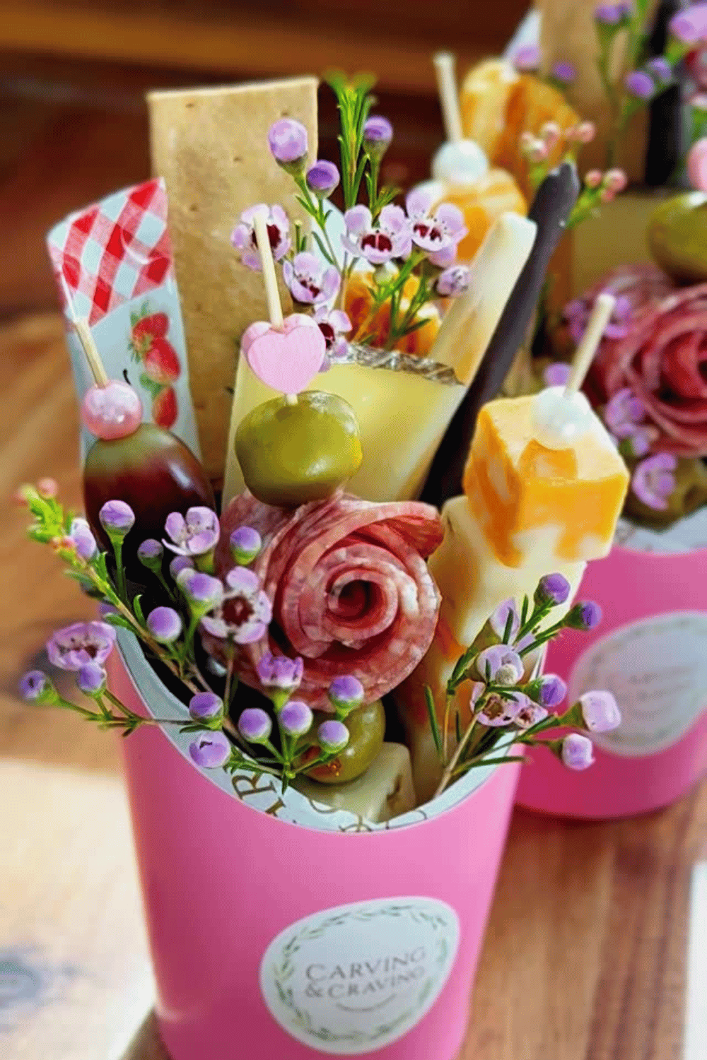 Edible charcuterie bouquet made with meats, cheese, and fruit