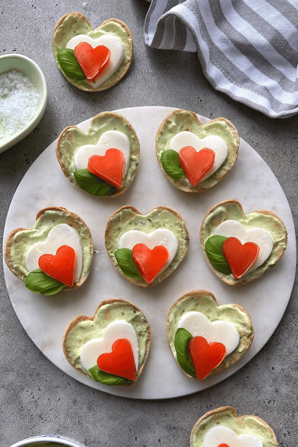 Heart-shaped toast snacks with cheese and tomato