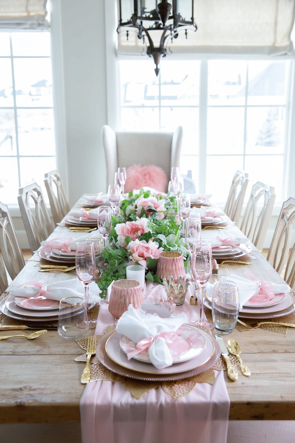 Styled galentine’s brunch table with pink napkins, florals, and table settings