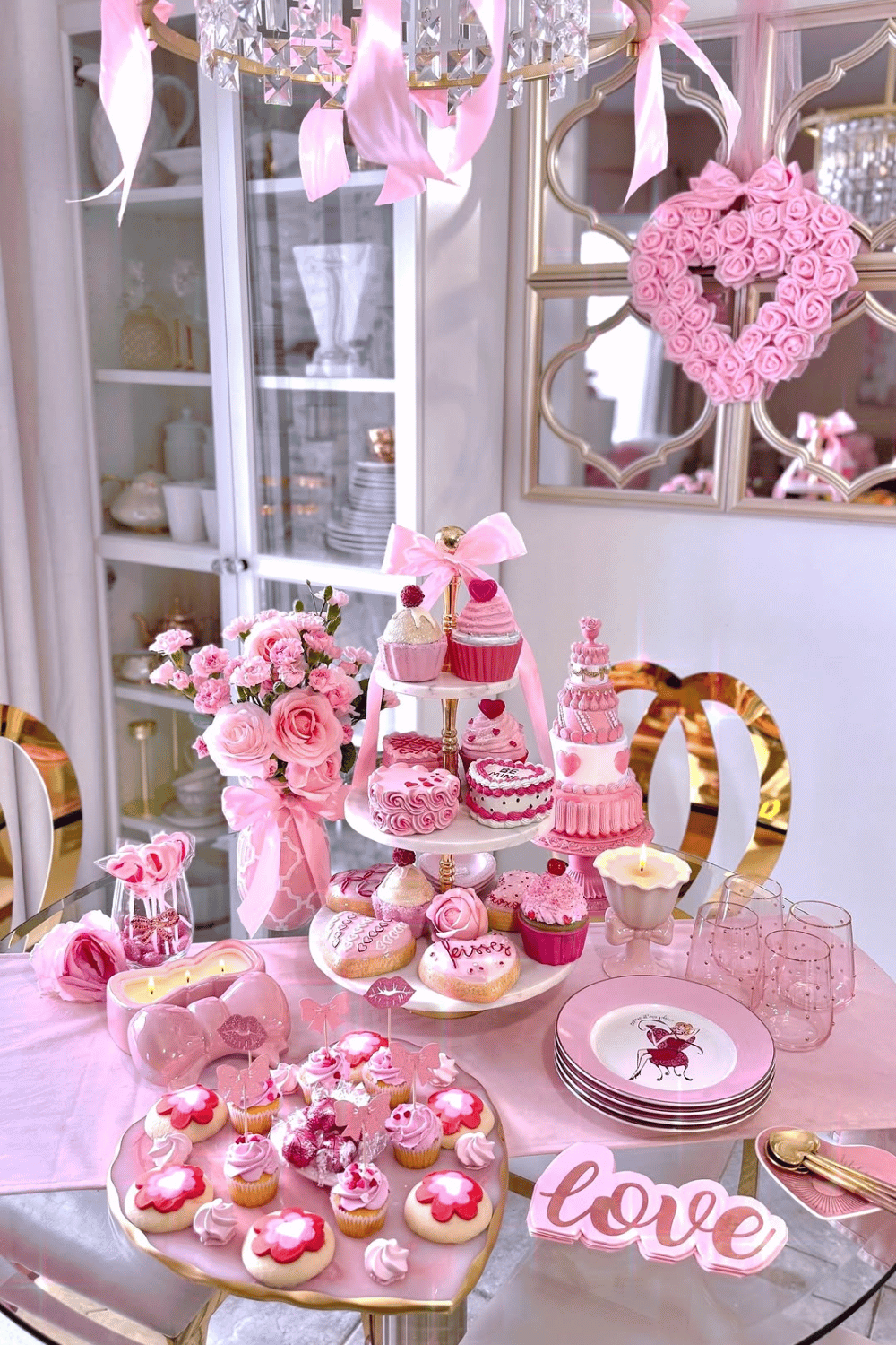 Galentine’s dessert table with cupcakes, cakes, and pink decorations