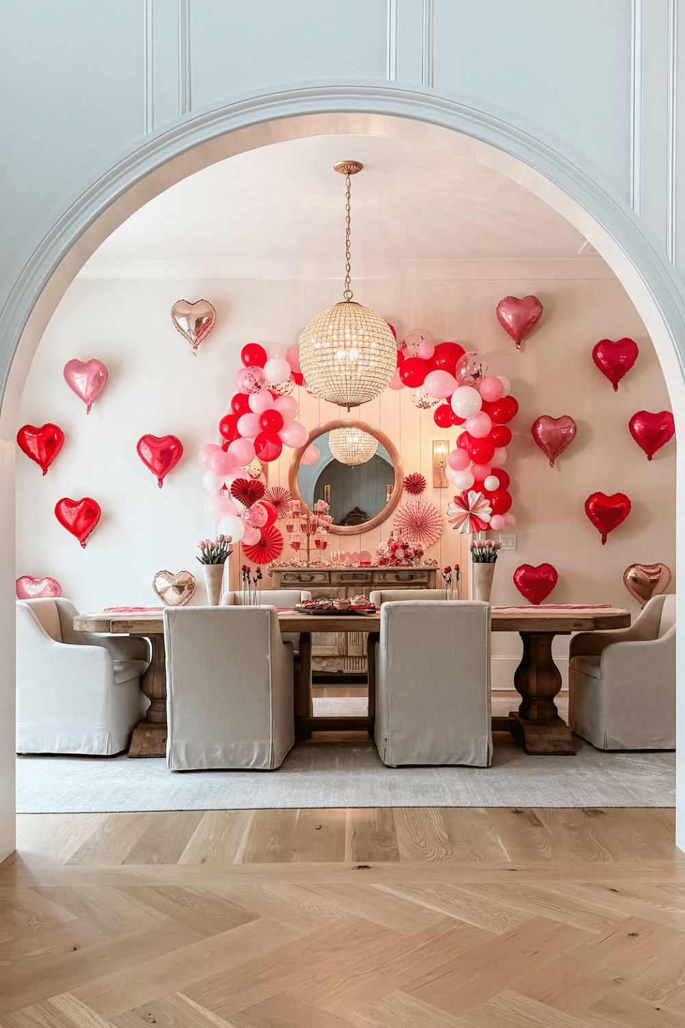Home galentine’s party backdrop with balloon arch and heart decorations