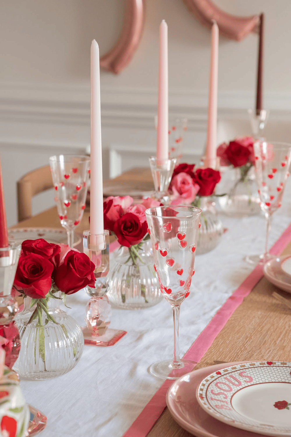 Galentine’s table runner with pink candles, roses, and heart glasses