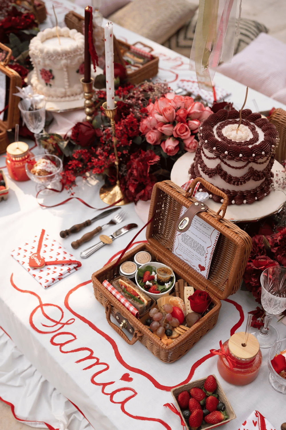 Galentine’s picnic spread with desserts, flowers, and pink decor