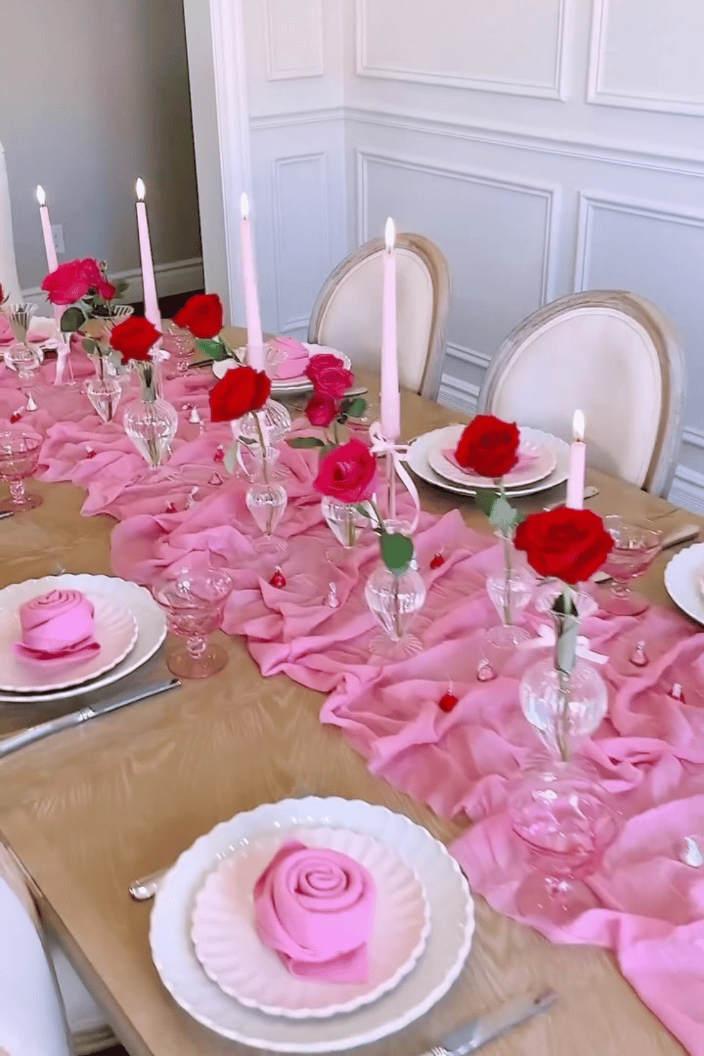 Romantic Galentine’s table with flowing pink fabric runner and rose centerpieces
