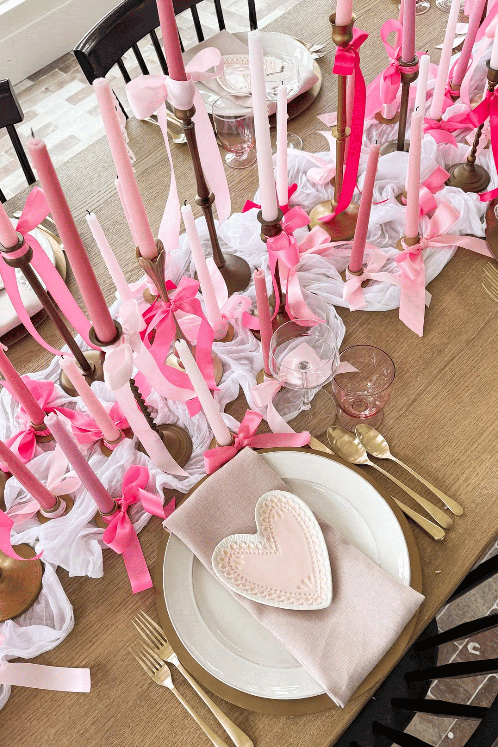 Galentine’s tablescape with ribbon-tied candles, heart napkins, and pink decor