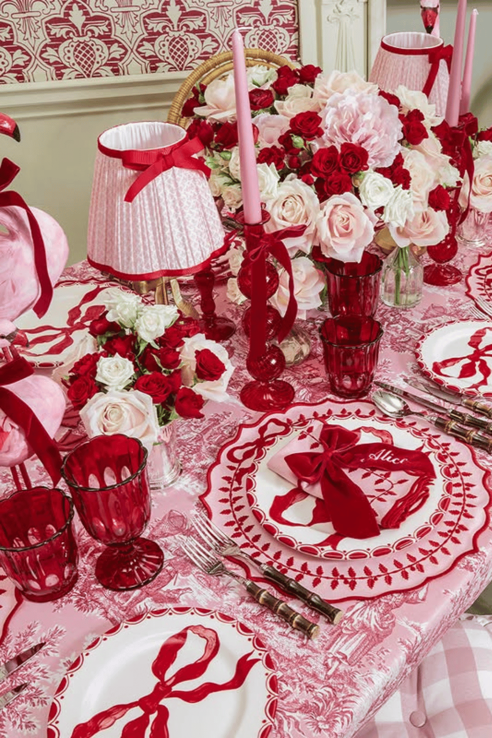 Romantic Galentine’s tablescape with red napkins, patterned linens, and floral details